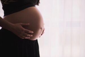 Pregnant woman holding belly